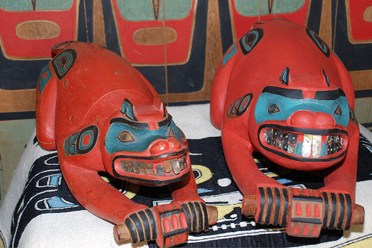 The original beaver prow next to the newly-carved replica.