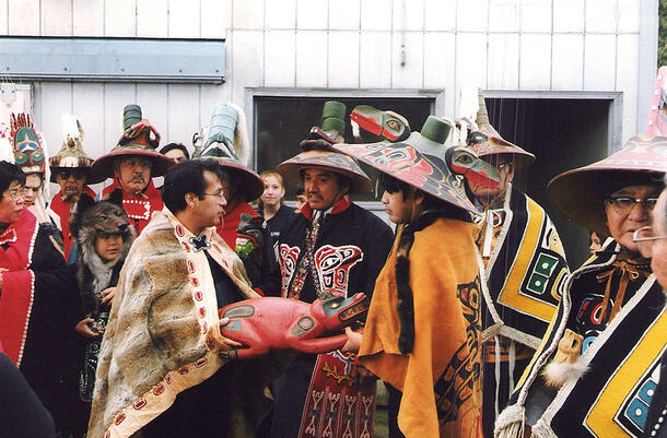 Angoon villagers gather around the original beaver prow.