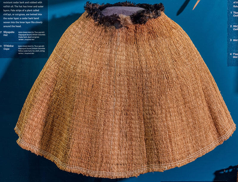 Cape fashioned from cedar bark has a textured appearance.