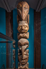 Carved wooden totem pole comprised of four figures is located inside the Museum's Northwest Coast Hall.
