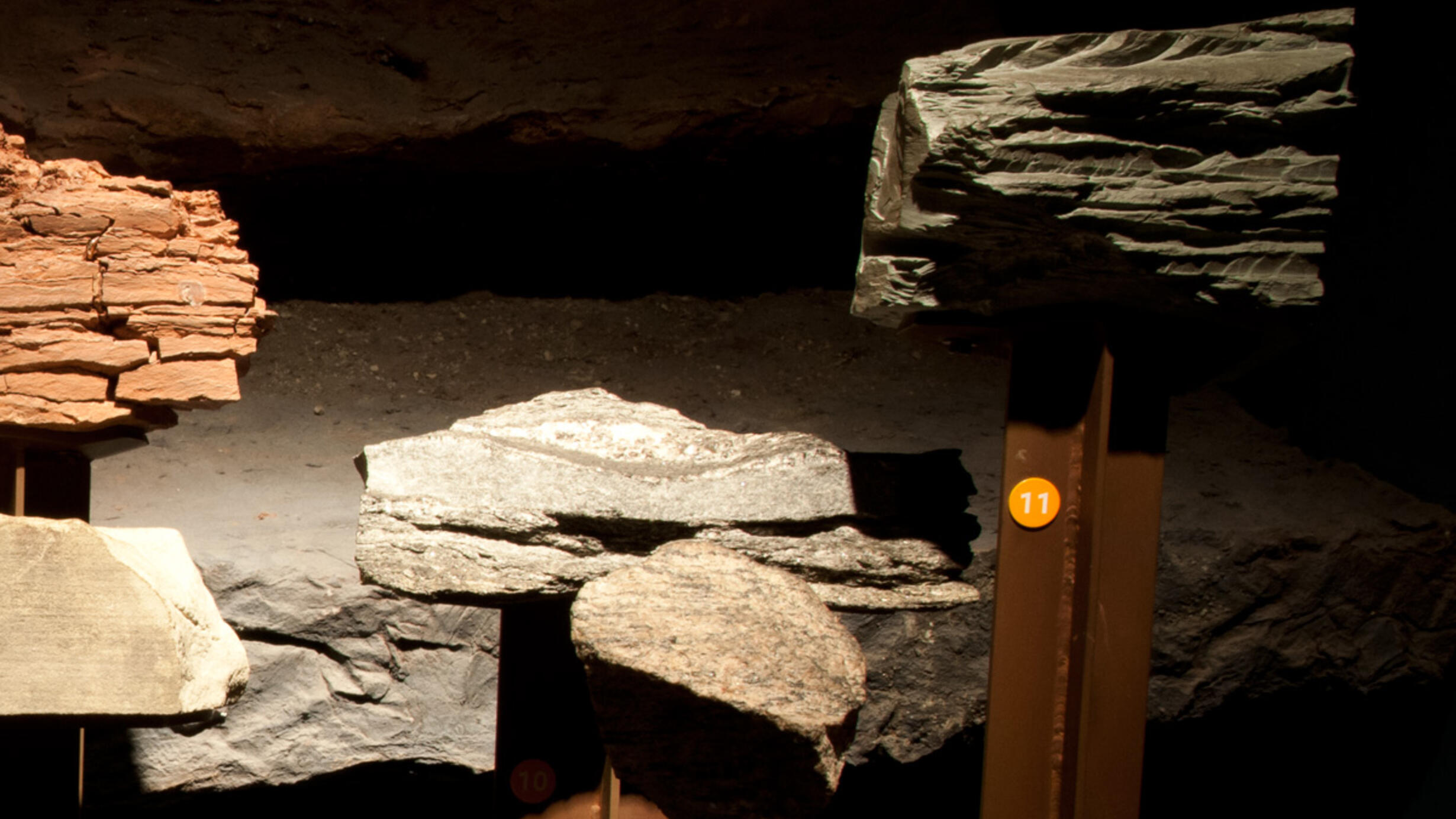 In the Museum’s Hall of Planet Earth, several specimens of metamorphic rocks on display. One rock display base is marked with the number eleven.