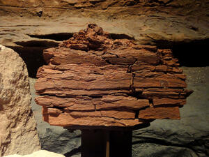 Large piece of layered shale rock on display.