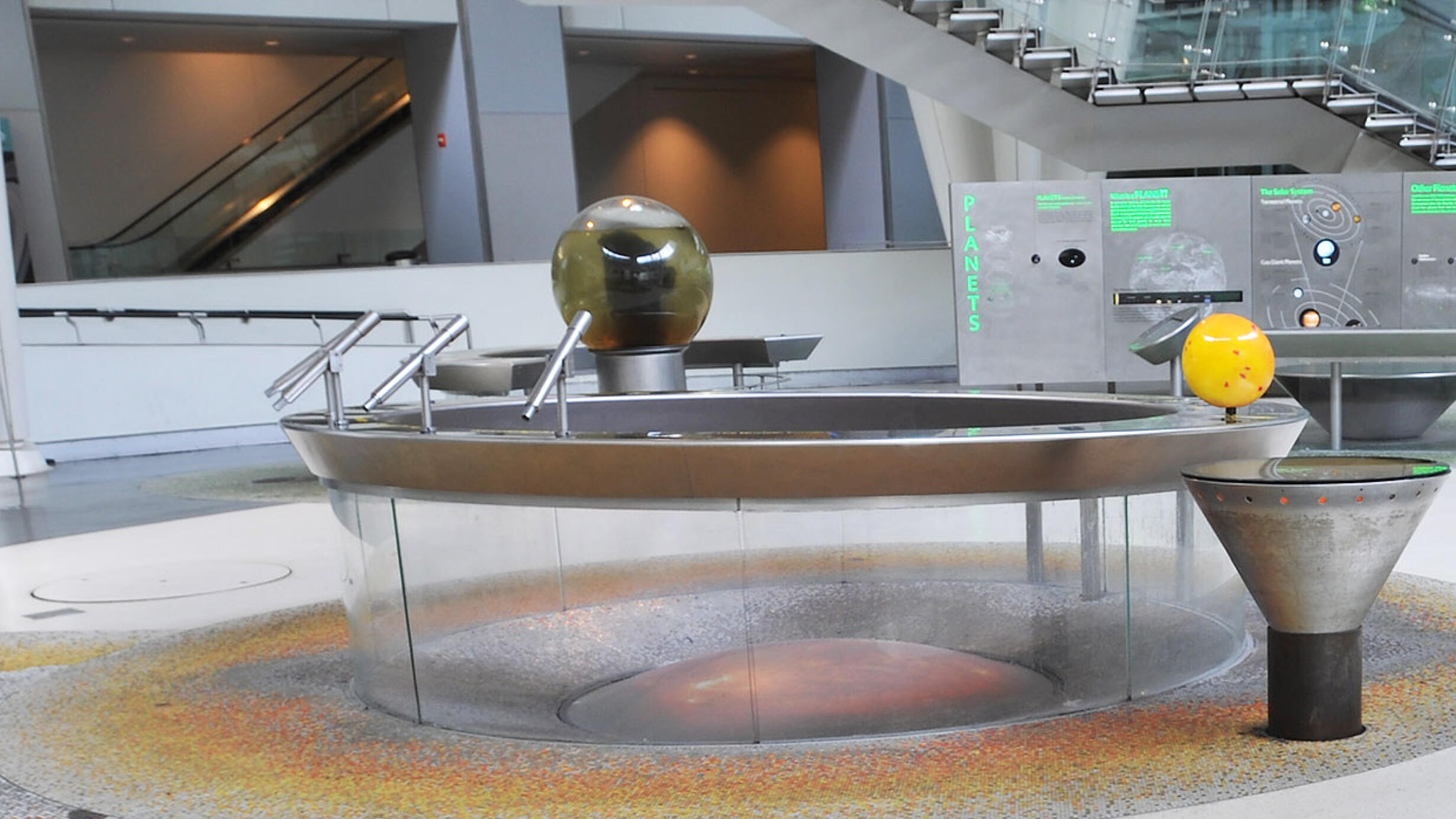 Panoramic view of the Museum's Hall of the Universe, with the glass ecosystem sphere in view.