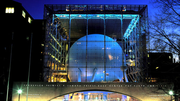 Exterior view at dusk of the glass-walled Rose Center at the American Museum of Natural History.