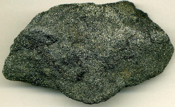 Dark colored rock with glittering specks all over.