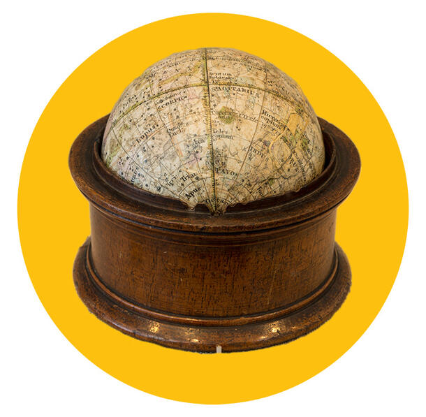 Detailed celestial globe in a wooden stand. 