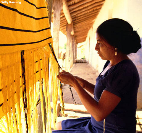 Guaraya weaver working on a hammock, in Urubichá, Bolivia