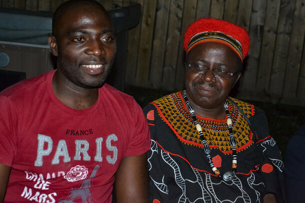 Scientist Jude Kong sits next to a community leader.