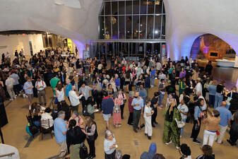 Over a hundred partygoers in the Gilder Center's  Kenneth C. Griffin Exploration Atrium at the Mead Film Festival's opening night reception.
