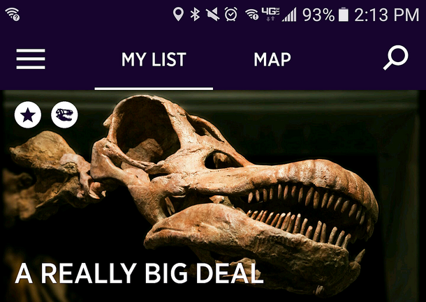 Home screen of the app displaying the head and teeth of the titanosaur, along with phone and menu icons.