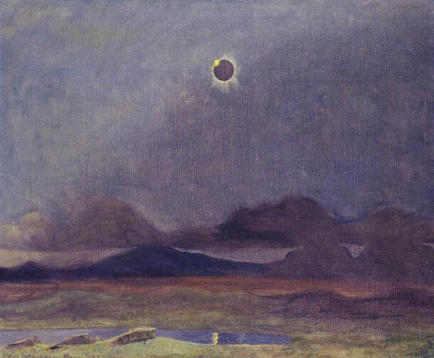 Mountainous landscape with the sun overhead obscured by the moon.