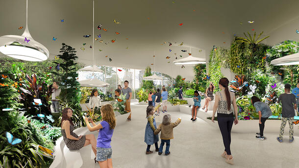 Visitor stroll through an expansive space of sweeping design filled with lush greenery and butterflies.