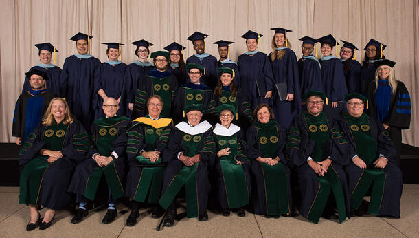 Formal group photo of graduates in robes.