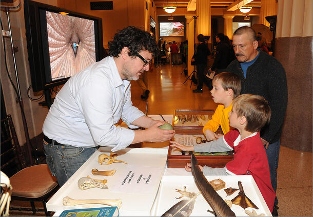 Paul Sweet inspects the specimens submitted by two young Museum visitors.