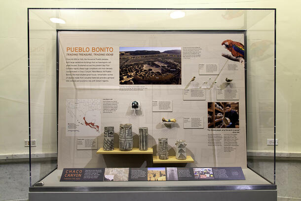 Display case shows various objects, such as pottery and bird figurines, with descriptive signage, as well as a large sign that reads "Pueblo Canyon".