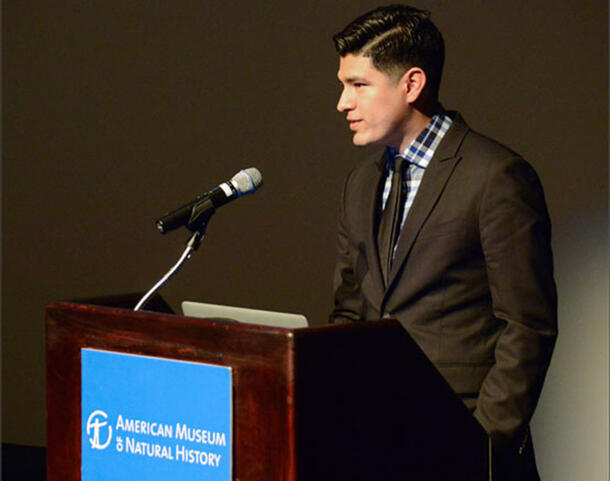 Adolfo Lara (Richard Gilder Graduate School) stands at a podium at the American Museum of Natural History.