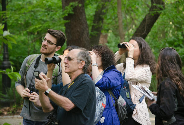 Spencer Galen speaks to participants of the Museum Birdwalk as they walk through Central Park.