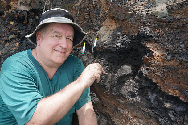 John Flynn excavates specimens in the field.