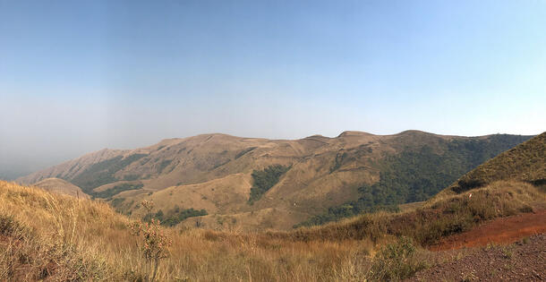 Panoramic landscape of mountain peaks and valleys.