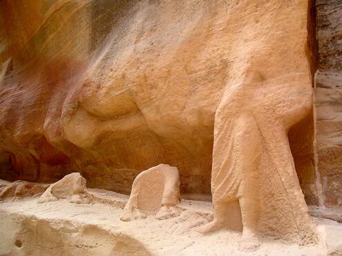 remains of stone carvings of a man's legs and two pairs of camel hooves