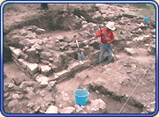 Crew works to remove the rubble covering a wall of a house