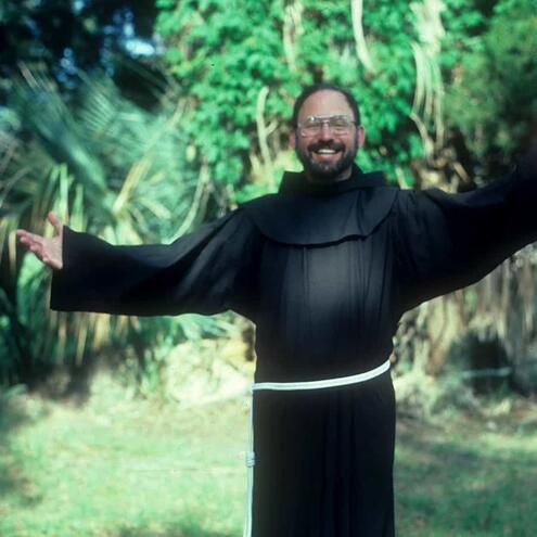 Father Conrad posing in his robes