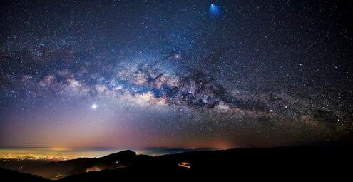 Nighttime view of a rocket, meteor, and the Milky Way Galaxy over Thailand