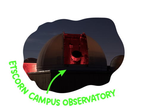 Image of a large telescope glowing red at night