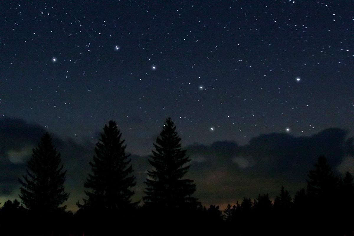 The Big Dipper shining brightly against a field of stars in the night sky. 