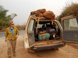 Melanie beside truck with back doors open showing all the gear