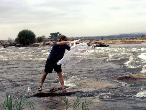 Team member throwing a cast net