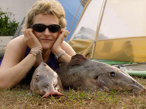 Melanie next to two catfish