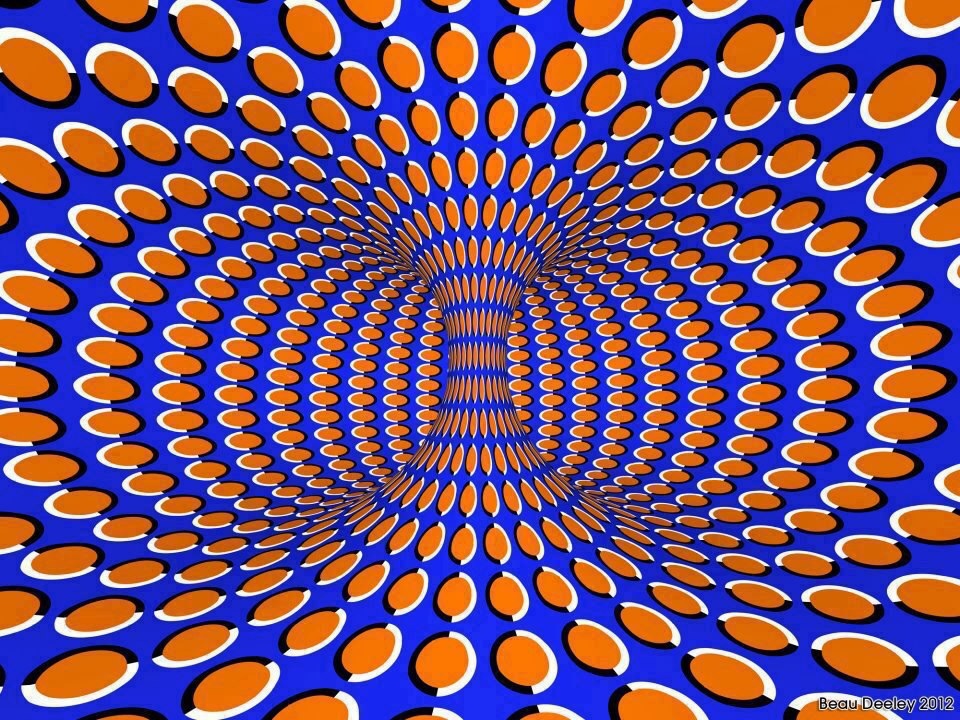 Interior view of a donut-shaped room, patterned with orange dots over a purple background. The pattern creates the illusion that the room is turning.
