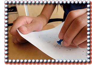 using a pushpin to punch out the message dots