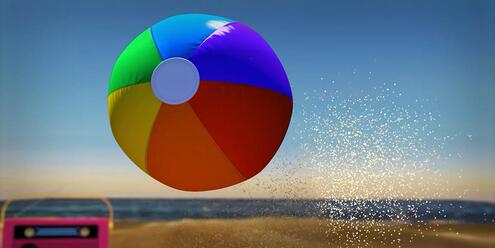 Sunny beach scene showing beach ball in the air and a radio in the sand in the background.