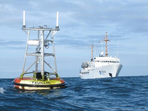 Buoy in ocean near ship