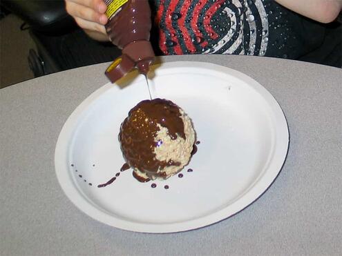 squirting magic chocolate on the Rice Krispie ball