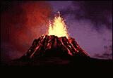 An erupting volcano with vertical lava and thin streasm of lava running down the volcano bright against the dark background.