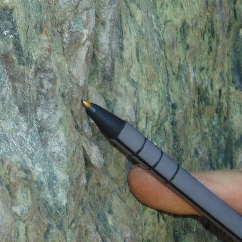 close up of serpentinite which is green with squiggly patterns