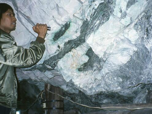 looking at jade streaks on walls inside the mine