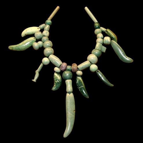 jade necklace of round beads and dangling pendants