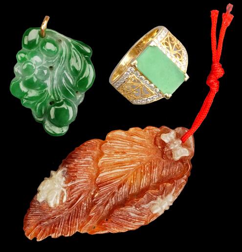 gold ring with rectangular jade stone and 2 carved pieces, 1 in vivid green and the other in orange