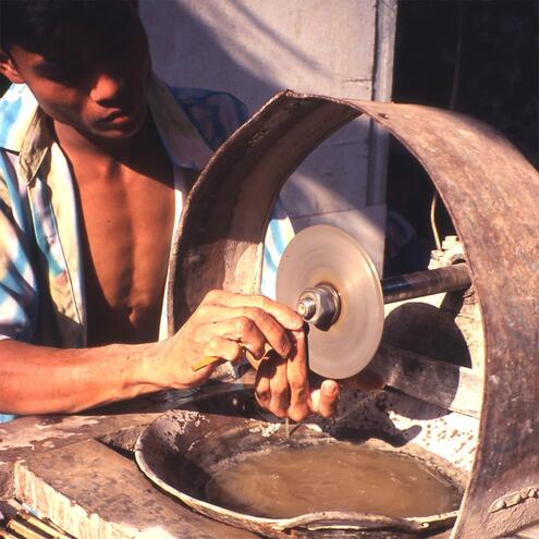 man carving jade with motorized machine
