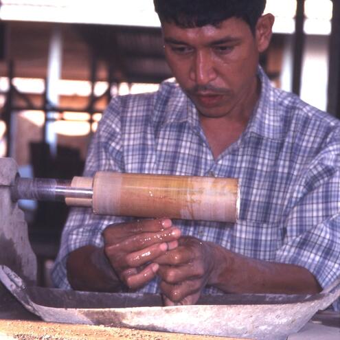 man polishing jade with machine that uses bamboo