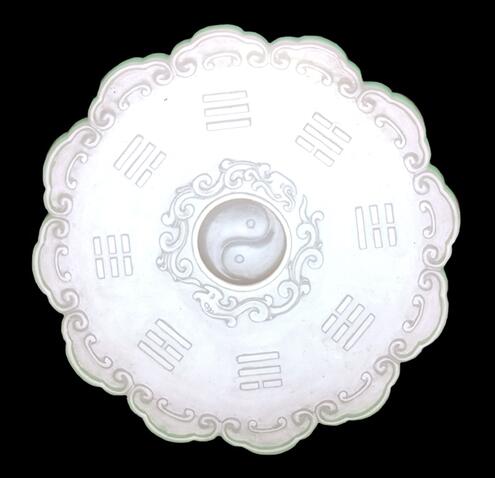 ornate carved disk in pure white jade