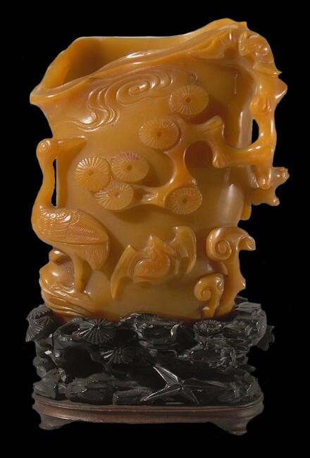 carving made of jade that was stained orange by rust