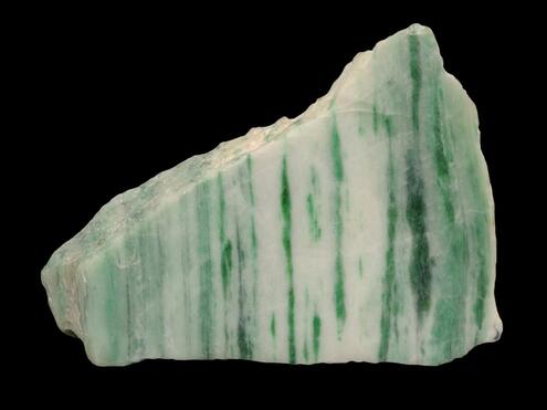 chunk of white jade with green vertical striations in it