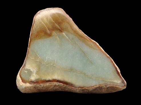 triangular piece of jade with pale blue green color in center and orange brown tinges on the edges