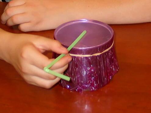 laying flexible straw on top of plastic wrap with the end of the straw in the center of the can
