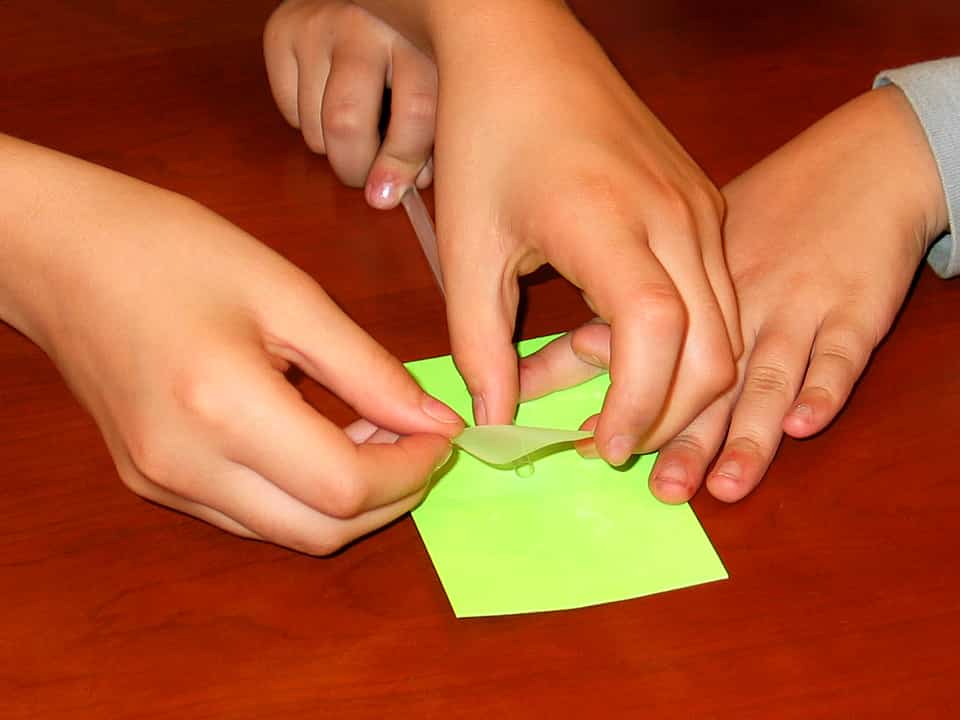 taping straight straw to center of neon yellow post-it note